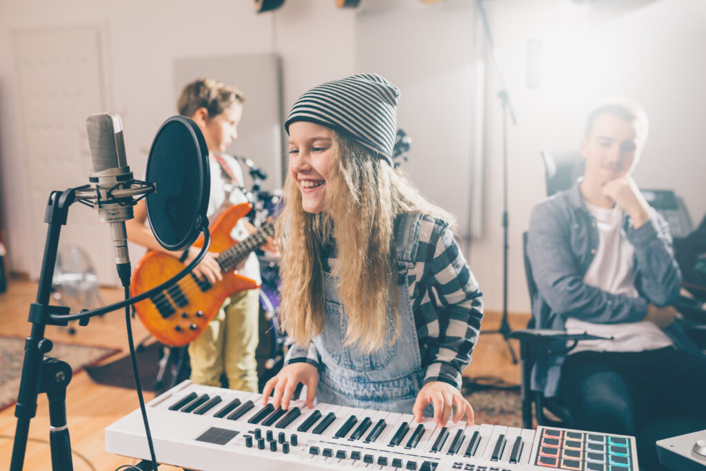kids rock band practice in music studio